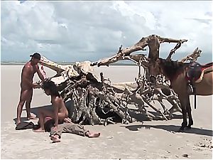 kinky mexican chick gets 2 meatpipes on the beach